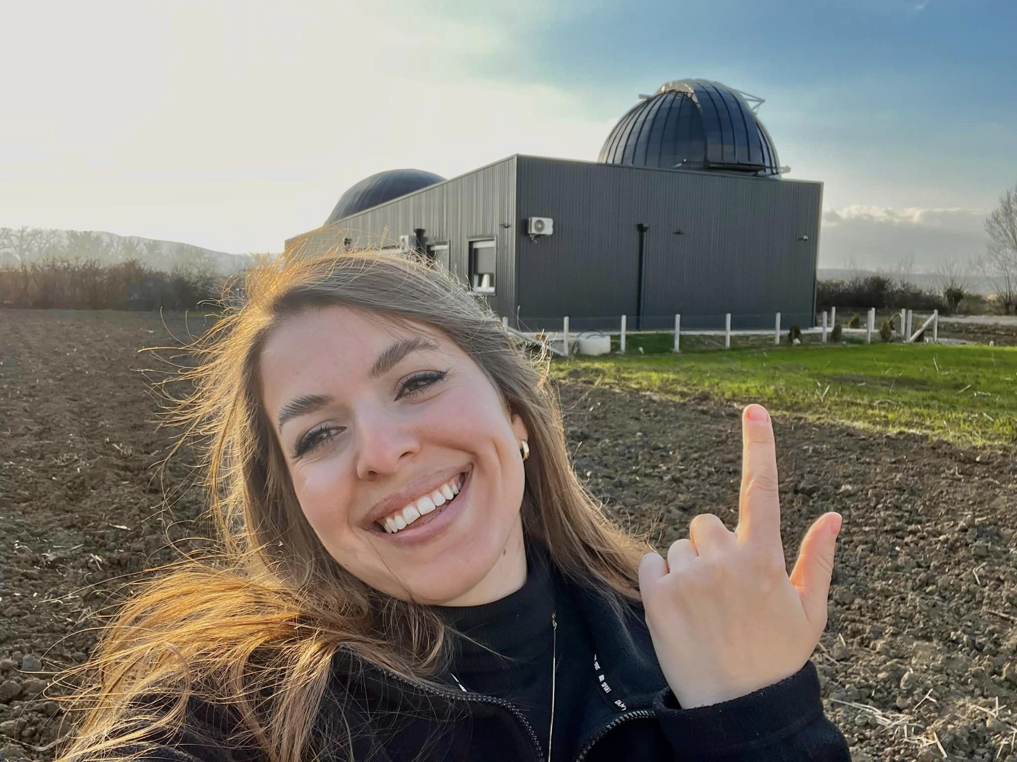 UC Santa Cruz Ph.D. student Pranvera Hyseni in front of the soon-to-open National Observatory and Planetarium in Shtime, Kosovo.