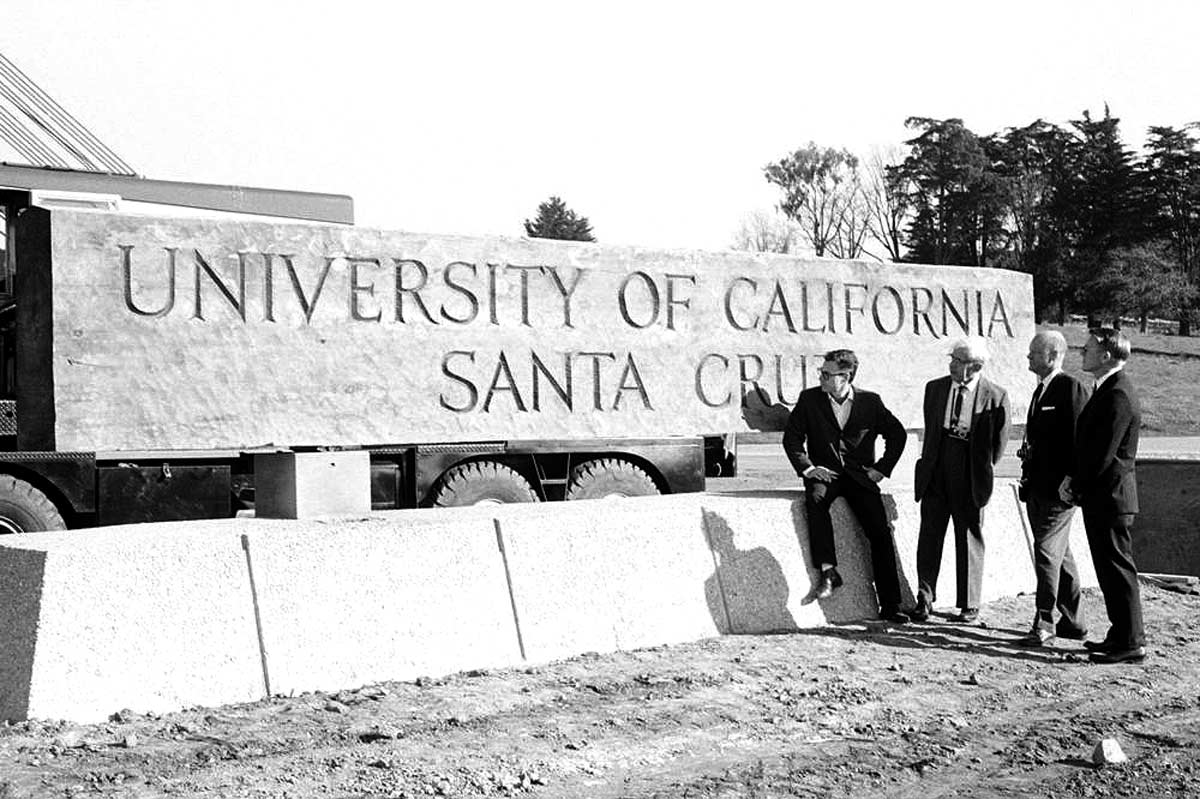 Dean McHenry and unknown executives at the University of California Santa Cruz sign