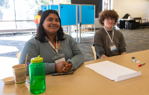 UC Santa Cruz student Anavi Deshmukh (left) and Santa Cruz High School student Andres Tremblay were volunteering at the Stevenson Event Center polling place Monday morning. (Photos by Carolyn Lagattuta)